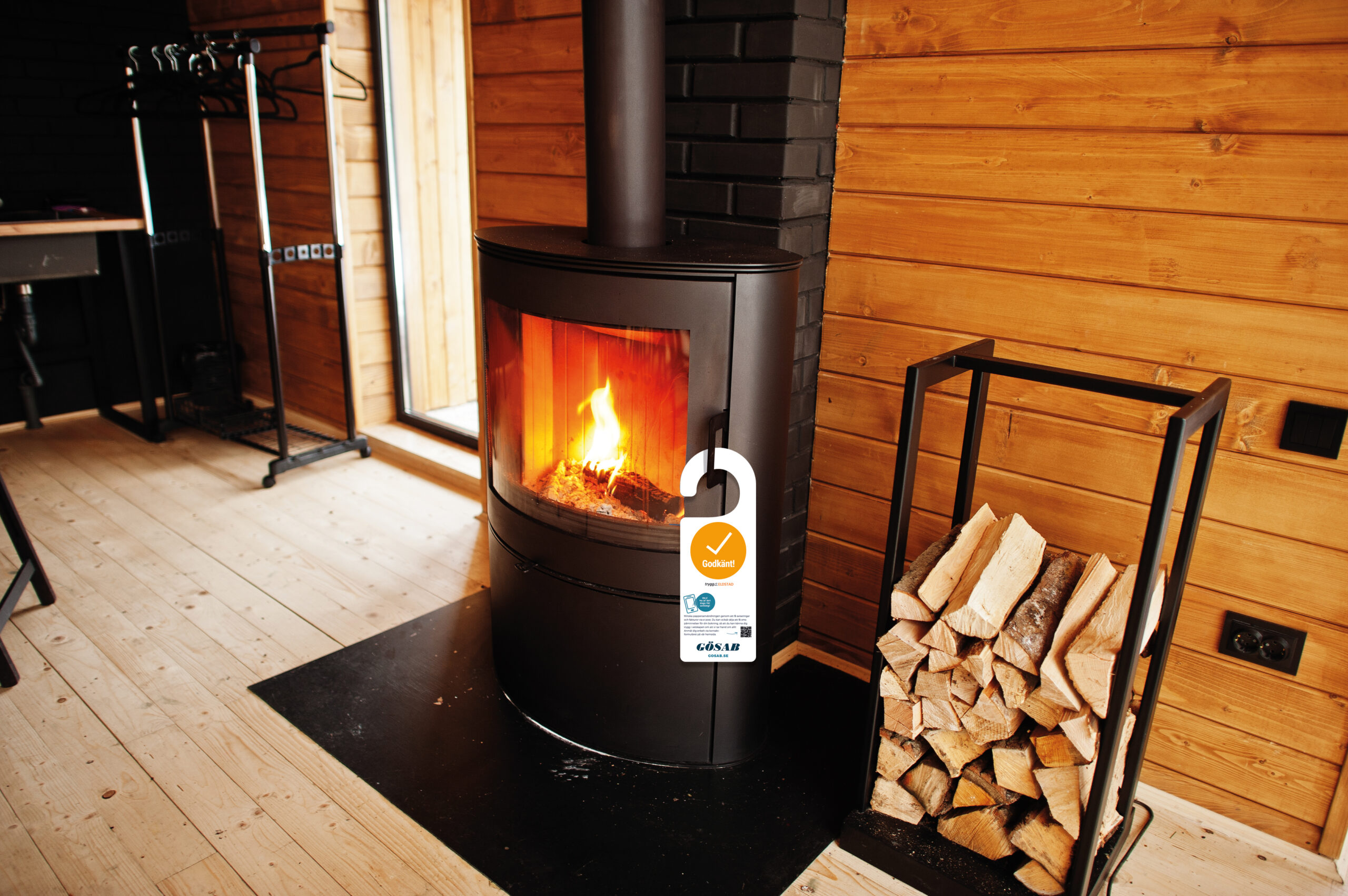 Fireplace with woods in modern wooden house. Gösab besiktning kamin
